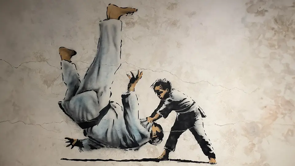 Grafika Banksego Street Art mural judo z Putinem